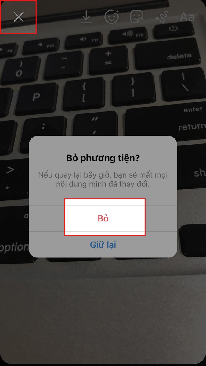 Nhấn vào biểu tượng dấu X ở góc trên bên trái > Nhấn Bỏ để xoá ảnh vừa chụp