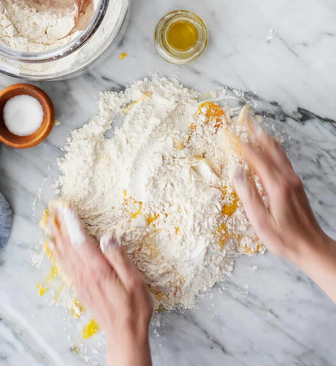 Kneading eggs and flour together