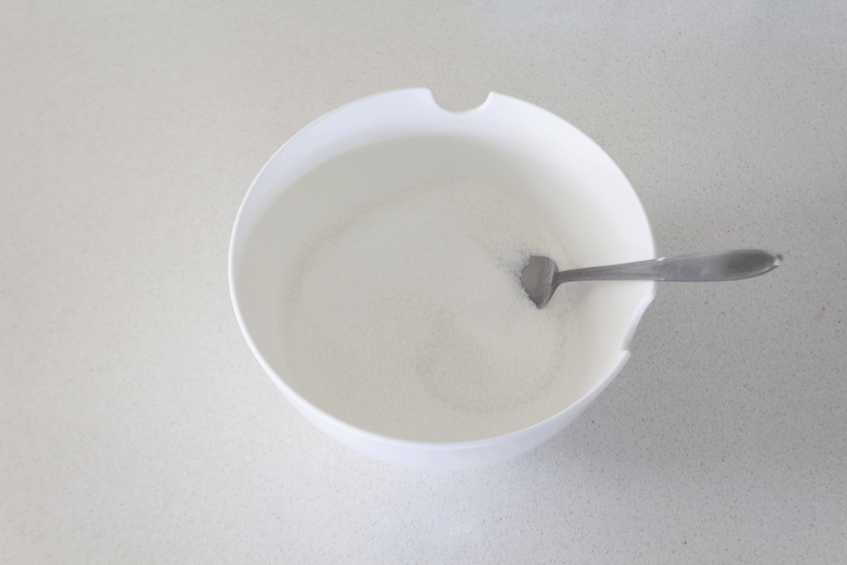 Sugar and jelly powder in a bowl with a fork in it.