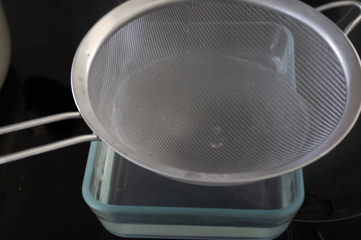 A sieve over a container.