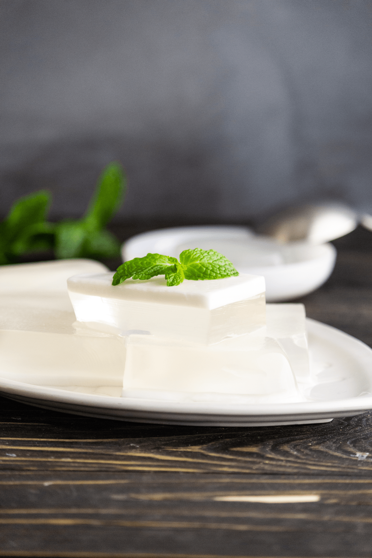 Thạch Dừa pieces on a plate with mint on top.