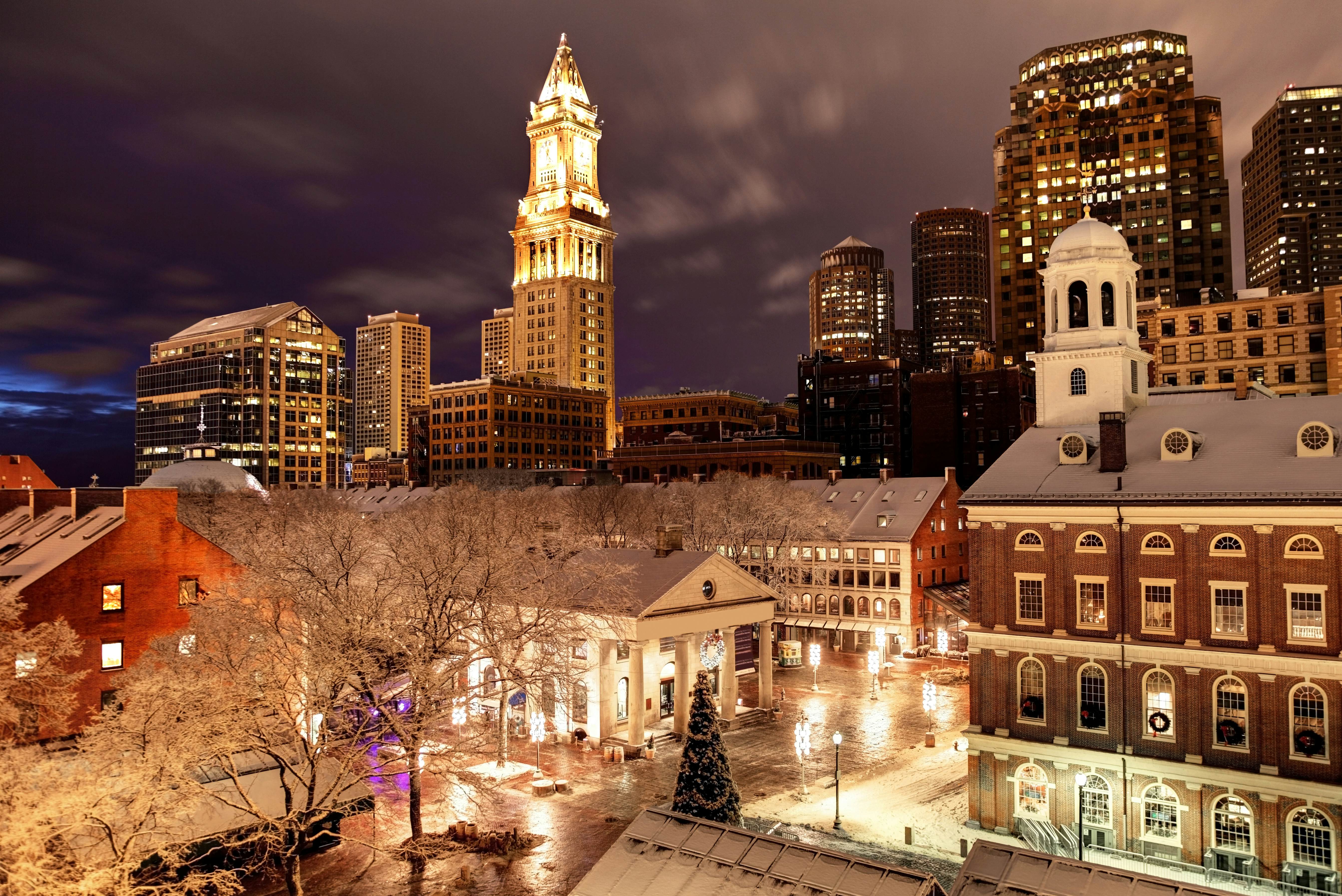 A dusting of snow covers bare tree branches in Faneuil Hall Marketplace. estive creative lighting and sparkling Christmas trees are everywhere as the Boston embraces the holiday season.