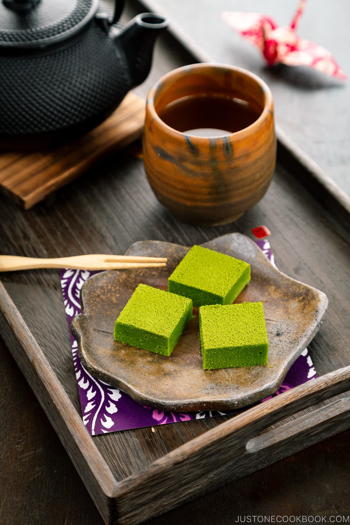 A Japanese plate containing matcha chocolate.