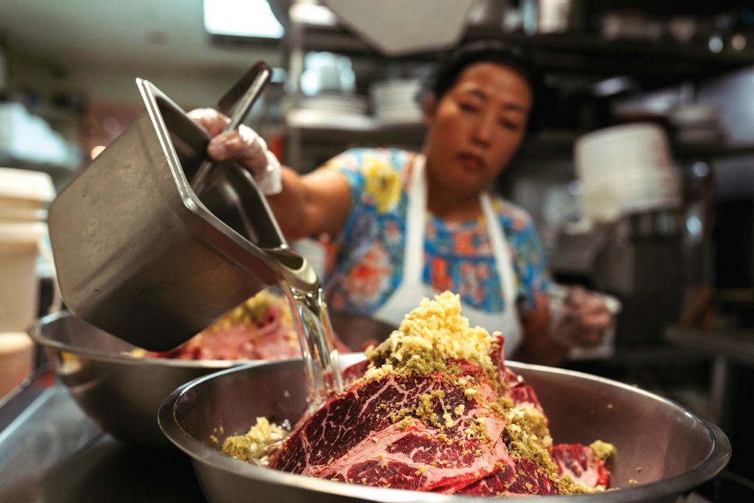 Kim La prepares the beef broth for Pho Cali’s pho, a process that takes 12 hours. La washes beef bones, soaks them in salt for two hours and then renders them for another 10.